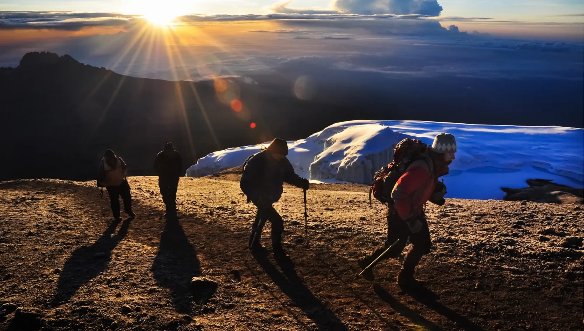 Climbers at sunrise on Kilimanjaro's summit ridge